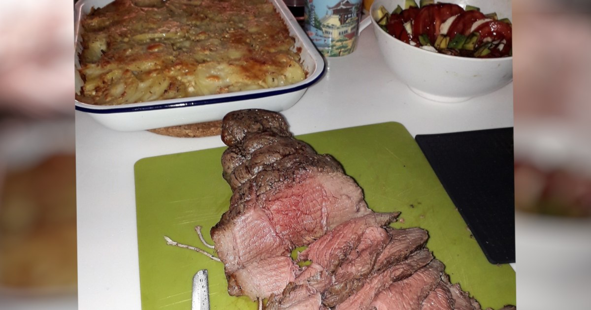 Sliced roast beef, baked casserole, and salad prepared in the galley of the Rapido 60 trimaran Ineffable.