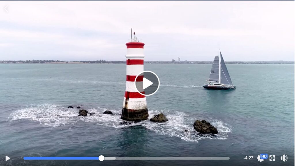 Romanza sails past lighthouse in the SSANZ Lewmar Triple Series Race in New Zealand, 1 August 2020. Screenshot from Live Sail Die video.