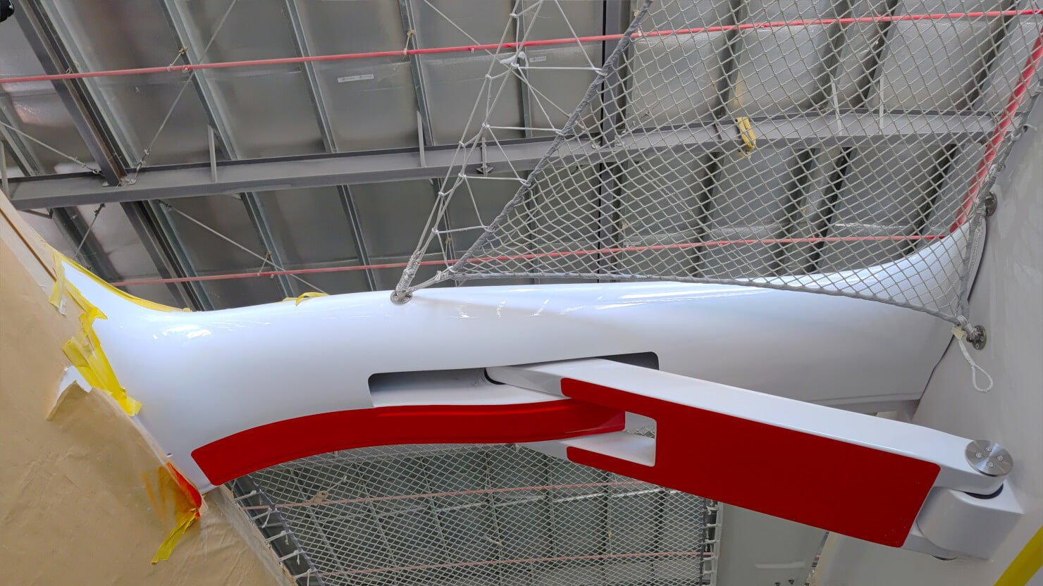 A Rapido 40’s beam and strut, made of prepreg and autoclave-cured together with titanium pins. The beams and struts let the f loats (amas) fold for marinas and shipping and add structural strength when deployed.