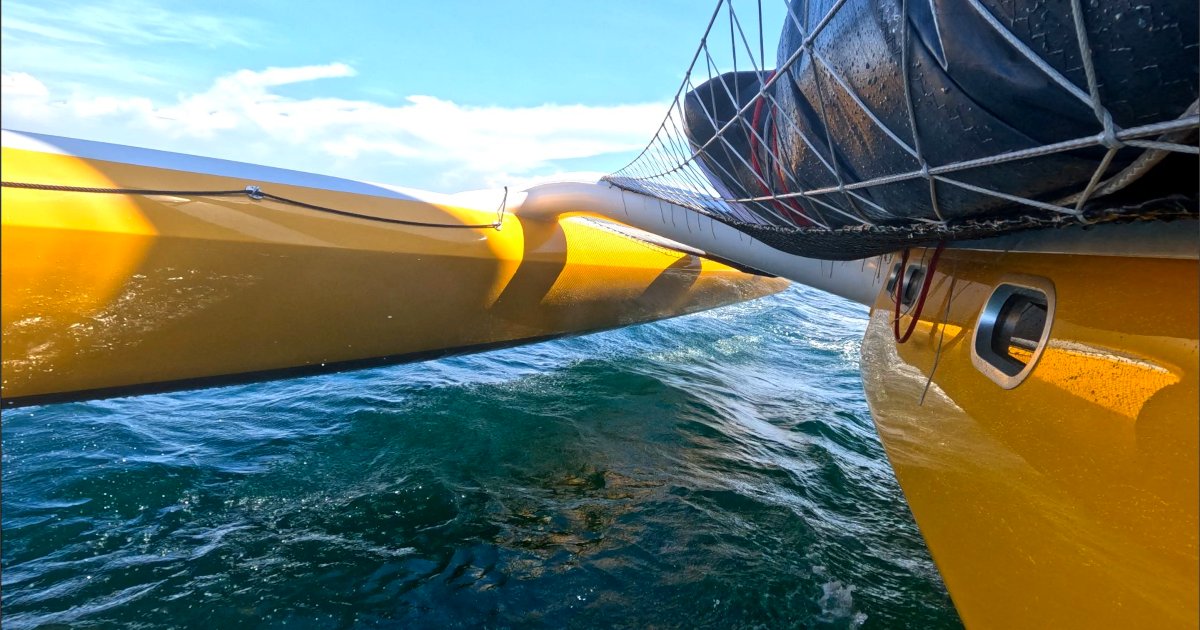 Rapido 60 trimaran sailing with its windward float lifted clear of the water